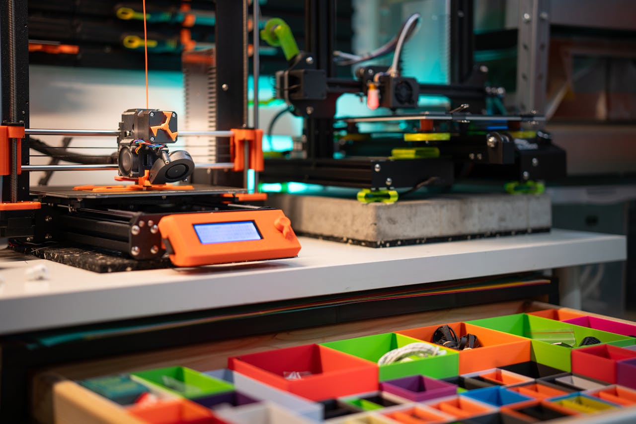 about-img Vibrant 3D printing station showcasing modern equipment and organized storage boxes.
