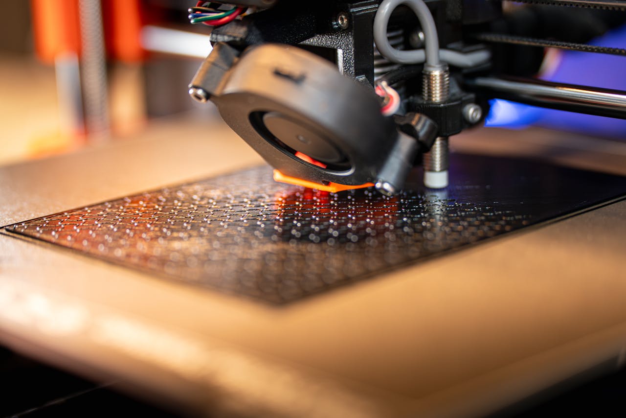 ours-journey Detailed view of a 3D printer in action, showcasing cutting-edge manufacturing technology.